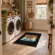 Knitting yarn quote area rug in black with coral, teal, yellow, and cream accents, wide interior view