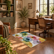 Pastel watercolor floral area rug in pink, yellow, green, blue, and lavender, complete product view