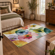 Pastel watercolor floral area rug in pink, yellow, green, blue, and lavender, soft surface detail