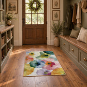 Pastel watercolor floral area rug in pink, yellow, green, blue, and lavender, wide interior view