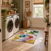 Pastel watercolor floral area rug in pink, yellow, green, blue, and lavender, design detail view