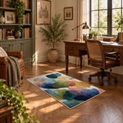 Pastel abstract pebble area rug in teal, navy, coral, yellow, and blush, complete product view