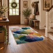 Pastel abstract pebble area rug in teal, navy, coral, yellow, and blush, close decorative detail