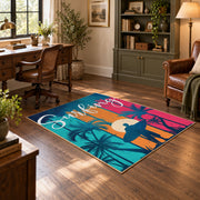 Sunset palm tree area rug in pink, teal, orange, navy, and cream, wood floor styling