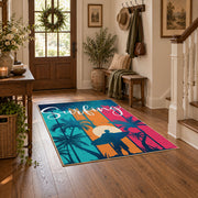 Sunset palm tree area rug in pink, teal, orange, navy, and cream, close decorative detail