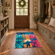 Sunset palm tree area rug in pink, teal, orange, navy, and cream, wide interior view