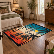California beach typography area rug in teal, orange, cream, and black, soft surface detail