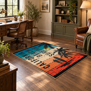 California beach typography area rug in teal, orange, cream, and black, wood floor styling