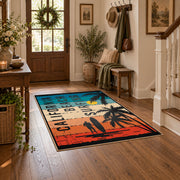 California beach typography area rug in teal, orange, cream, and black, close decorative detail