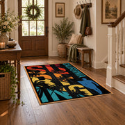 California palm collage area rug in black, orange, teal, yellow, and red, close decorative detail