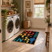 California palm collage area rug in black, orange, teal, yellow, and red, design detail view