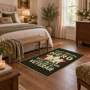 Veteran homecoming tribute area rug in black, red, cream, and green, cozy home setting