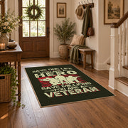 Veteran homecoming tribute area rug in black, red, cream, and green, close decorative detail