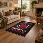 Space service emblem area rug in black, red, white, and gray, design detail view