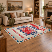 Veteran air mail graphic area rug in cream, red, blue, and black, angled room view