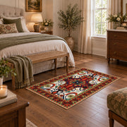 Red and blue ornate floral area rug with a traditional medallion pattern, cozy home setting