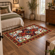 Red and blue ornate floral area rug with a traditional medallion pattern, soft surface detail