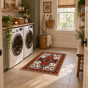 Red and blue ornate floral area rug with a traditional medallion pattern, wide interior view