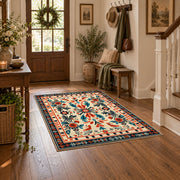 Cream and orange folk floral area rug with a symmetrical traditional pattern, wood floor styling