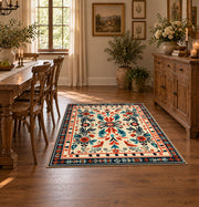 Cream and orange folk floral area rug with a symmetrical traditional pattern, close decorative detail