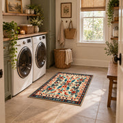 Cream and orange folk floral area rug with a symmetrical traditional pattern, wide interior view