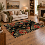 Black patchwork medallion area rug in red, beige, gold, and charcoal, featured room view