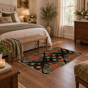Black patchwork medallion area rug in red, beige, gold, and charcoal, cozy home setting