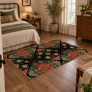 Black patchwork medallion area rug in red, beige, gold, and charcoal, full pattern view