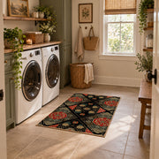 Black patchwork medallion area rug in red, beige, gold, and charcoal, wide interior view
