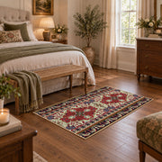 Burgundy floral medallion area rug with cream, teal, and gold details, cozy home setting