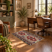 Burgundy floral medallion area rug with cream, teal, and gold details, complete product view