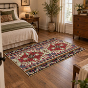 Burgundy floral medallion area rug with cream, teal, and gold details, full pattern view