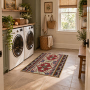 Burgundy floral medallion area rug with cream, teal, and gold details, wide interior view