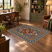 Teal and rust Persian floral area rug with an ornate allover pattern, wood floor styling