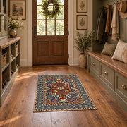 Teal and rust Persian floral area rug with an ornate allover pattern, front room mockup