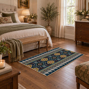 Blue multicolor Oriental area rug with a detailed traditional border, cozy home setting