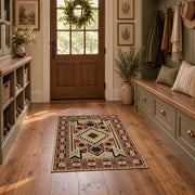 Beige and red tribal symbol area rug with a geometric Southwest-inspired pattern, wide interior view