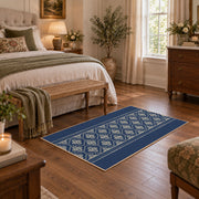 Blue and white geometric area rug with a minimal diamond pattern, cozy home setting