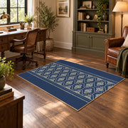 Blue and white geometric area rug with a minimal diamond pattern, wood floor styling