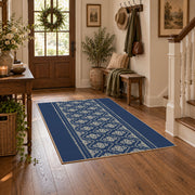 Blue and white geometric area rug with a minimal diamond pattern, close decorative detail