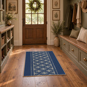 Blue and white geometric area rug with a minimal diamond pattern, wide interior view