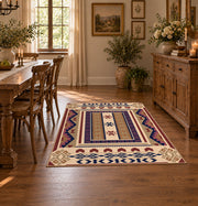 Beige and purple Southwestern area rug with bold tribal geometric motifs, close decorative detail
