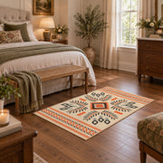 Cream and orange tribal diamond area rug with black and gray accents, cozy home setting