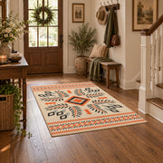 Cream and orange tribal diamond area rug with black and gray accents, wood floor styling