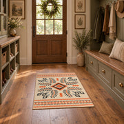 Cream and orange tribal diamond area rug with black and gray accents, front room mockup