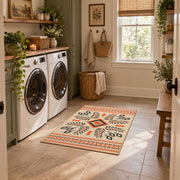 Cream and orange tribal diamond area rug with black and gray accents, wide interior view