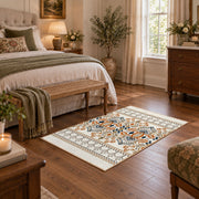 Cream and blue folk floral area rug with orange botanical details, cozy home setting