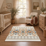 Cream and blue folk floral area rug with orange botanical details, full pattern view