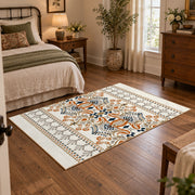 Cream and blue folk floral area rug with orange botanical details, soft surface detail
