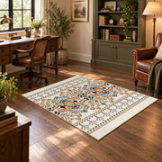 Cream and blue folk floral area rug with orange botanical details, wood floor styling